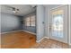Inviting living room with hardwood floors, a ceiling fan, and a large window with wooden blinds at 32589 Greenwood Loop, Wesley Chapel, FL 33545