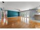 Inviting living room with hardwood floors, adjacent to kitchen and backyard access at 32589 Greenwood Loop, Wesley Chapel, FL 33545