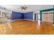 Spacious living room with hardwood floors, colorful accent walls, and natural light at 32589 Greenwood Loop, Wesley Chapel, FL 33545