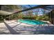 The screened-in pool offers an outdoor oasis with a spacious patio and privacy at 32589 Greenwood Loop, Wesley Chapel, FL 33545