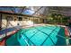 The outdoor space features a screened-in pool surrounded by lush landscaping at 32589 Greenwood Loop, Wesley Chapel, FL 33545