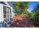 A wooden back deck features a wooden railing, glass french doors, and lush landscaping in the backyard at 10952 61St Ave, Seminole, FL 33772