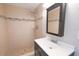 Bathroom features a tiled shower, modern vanity, and a decorative mirror at 10952 61St Ave, Seminole, FL 33772