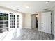 Bright bedroom with patio access, a white closet door and an adjacent bathroom at 10952 61St Ave, Seminole, FL 33772