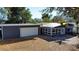 Exterior shot of house with white garage door, mature trees and appealing curb appeal at 10952 61St Ave, Seminole, FL 33772