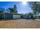 Charming single-story home featuring a large attached garage and manicured gravel yard at 10952 61St Ave, Seminole, FL 33772