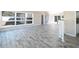 Spacious living room with tiled floors, bright windows, and a staircase with a white banister at 10952 61St Ave, Seminole, FL 33772