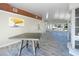 Bright, open living room with wood-look flooring and a large window and decorative wall art at 10952 61St Ave, Seminole, FL 33772