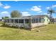 A spacious backyard with a large screened lanai and mature landscaping at 523 Red Mangrove Ln, Apollo Beach, FL 33572