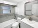 A modern bathroom featuring a tub, shower, modern vanity and tile accent wall at 523 Red Mangrove Ln, Apollo Beach, FL 33572