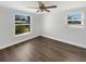 Bedroom featuring hardwood floors, two windows and bright white walls at 523 Red Mangrove Ln, Apollo Beach, FL 33572