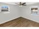 Comfortable bedroom with natural light streaming through two windows and stylish vinyl floors at 523 Red Mangrove Ln, Apollo Beach, FL 33572