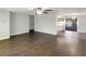 Bright living room featuring hardwood floors, a ceiling fan, and a view of the kitchen and sliding glass doors at 523 Red Mangrove Ln, Apollo Beach, FL 33572