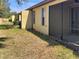 Backyard featuring a small yard, screened patio, and fencing at 5485 Sunset Falls Dr, Apollo Beach, FL 33572