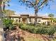 Charming single-story home with a tile roof, lush landscaping, and a well-maintained front yard at 5485 Sunset Falls Dr, Apollo Beach, FL 33572