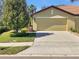 Home exterior with garage, driveway, and landscaping at 5485 Sunset Falls Dr, Apollo Beach, FL 33572