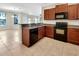Kitchen view showcasing dark wood cabinets, granite countertops, and stainless steel appliances at 5485 Sunset Falls Dr, Apollo Beach, FL 33572