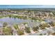Aerial view captures a lakeside home with a picturesque street view and neighborhood charm at 15121 Searobbin Dr, Lakewood Ranch, FL 34202