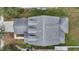 Overhead view shows the roof's design, including dormers, shingles and lawn at 15121 Searobbin Dr, Lakewood Ranch, FL 34202