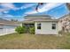 The backyard showcases a beautiful lawn and the home's architecture at 15121 Searobbin Dr, Lakewood Ranch, FL 34202
