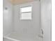 Bathroom featuring a tiled wall, a tub, and a window at 15121 Searobbin Dr, Lakewood Ranch, FL 34202