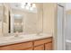 Bathroom featuring double sinks, a large mirror, and an adjacent room at 15121 Searobbin Dr, Lakewood Ranch, FL 34202