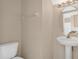 Bathroom featuring a toilet, sink, mirror, and lights at 15121 Searobbin Dr, Lakewood Ranch, FL 34202