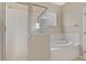 Bathroom featuring a shower with glass doors, a soaking tub, and a window at 15121 Searobbin Dr, Lakewood Ranch, FL 34202