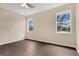 Serene bedroom with hardwood floors, ample natural light, and a ceiling fan at 15121 Searobbin Dr, Lakewood Ranch, FL 34202