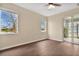 Comfortable bedroom featuring hardwood floors, natural light and a ceiling fan at 15121 Searobbin Dr, Lakewood Ranch, FL 34202