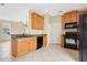 Functional kitchen features modern appliances, wooden cabinets, and a breakfast bar at 15121 Searobbin Dr, Lakewood Ranch, FL 34202