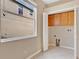 Bright laundry room featuring a window, built in cabinets, and bi-fold doors at 15121 Searobbin Dr, Lakewood Ranch, FL 34202