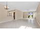 Bright living room featuring tile floors and sliding glass doors to the backyard at 15121 Searobbin Dr, Lakewood Ranch, FL 34202