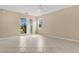 Bright living room featuring tile floors, sliding glass doors, and backyard views at 15121 Searobbin Dr, Lakewood Ranch, FL 34202