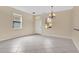 Inviting living area with tile flooring, chandelier, and natural light from two large windows at 15121 Searobbin Dr, Lakewood Ranch, FL 34202