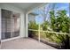 The patio featuring sliding glass doors, and a view of the greenery at 15121 Searobbin Dr, Lakewood Ranch, FL 34202