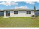 Spacious backyard with lush green grass and a sliding door to the home at 31610 Malbec Dr, Brooksville, FL 34602