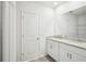 Bathroom featuring granite countertop, double sinks, and a large framed mirror at 31610 Malbec Dr, Brooksville, FL 34602