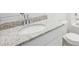 Bathroom features a vanity with a granite countertop and a white sink at 31610 Malbec Dr, Brooksville, FL 34602