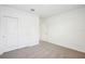 A simple bedroom with gray carpet and a double door closet at 31610 Malbec Dr, Brooksville, FL 34602