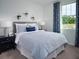 Inviting bedroom featuring soft blue bedding, lots of natural light, and decorative accents at 31610 Malbec Dr, Brooksville, FL 34602