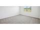 A room with a large window for plenty of natural light, with gray carpet at 31610 Malbec Dr, Brooksville, FL 34602
