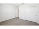 Bright bedroom with carpet flooring, white walls, and double door closet at 31610 Malbec Dr, Brooksville, FL 34602