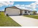 Inviting home exterior with a well-maintained lawn and a double car attached garage at 31610 Malbec Dr, Brooksville, FL 34602