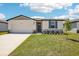 Charming single-story home with well-manicured lawn, attached garage, and welcoming entrance at 31610 Malbec Dr, Brooksville, FL 34602