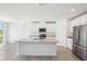 Bright kitchen featuring a granite island, stainless steel appliances, and ample cabinet space at 31610 Malbec Dr, Brooksville, FL 34602