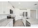 Modern kitchen features white cabinets, granite countertops, and stainless steel appliances at 31610 Malbec Dr, Brooksville, FL 34602