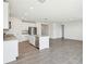 Open-concept kitchen with granite countertops and stainless-steel appliances flows to living area at 31610 Malbec Dr, Brooksville, FL 34602