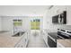 The kitchen features granite countertops, stainless-steel appliances, and flows into an open space at 31610 Malbec Dr, Brooksville, FL 34602