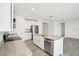 Modern kitchen features white cabinets, granite countertops, and stainless steel appliances at 31610 Malbec Dr, Brooksville, FL 34602